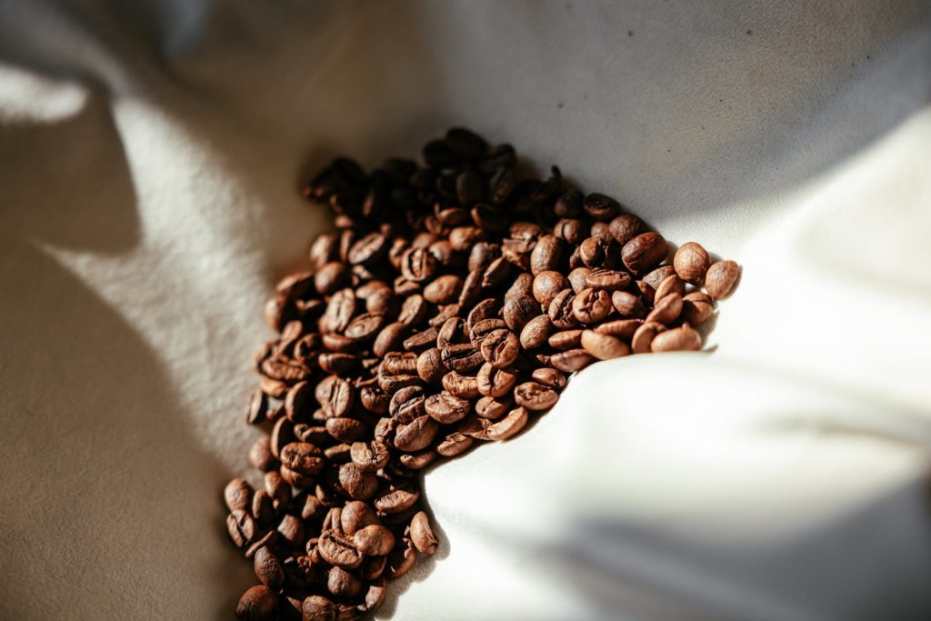 Coffee beans lying on a surface.